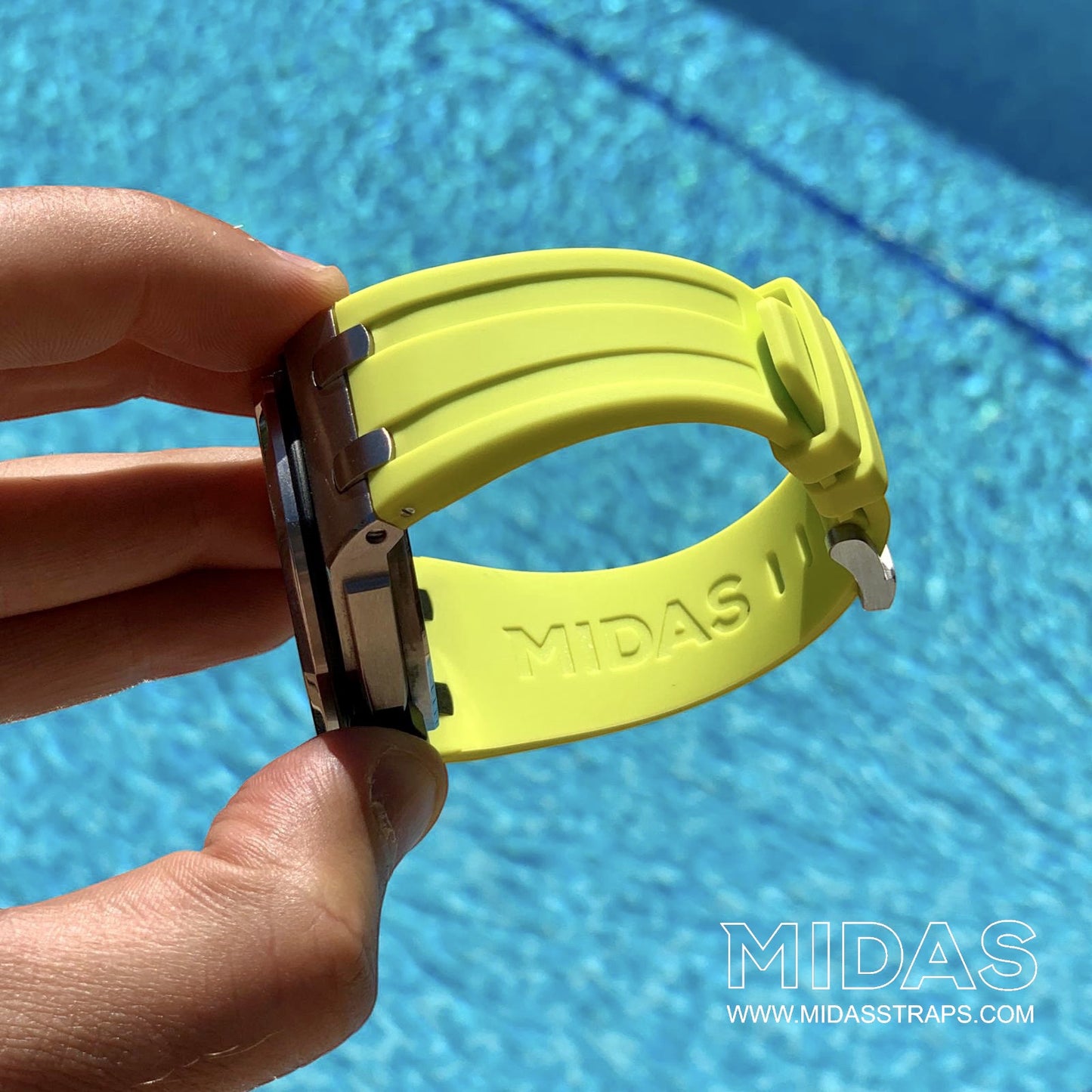 MIDAS Royal Oak Offshore 42mm acid green rubber strap on wrist outdoor pool background