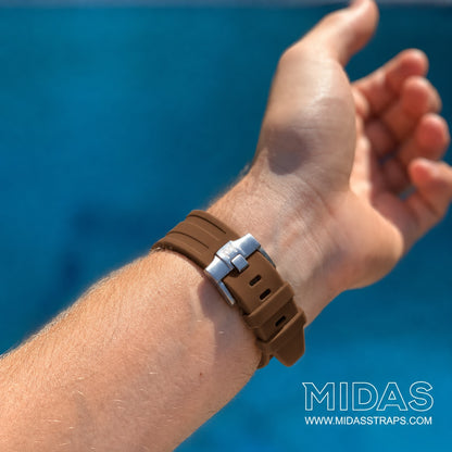 MIDAS Royal Oak Offshore 42mm brown rubber strap on wrist outdoor pool background