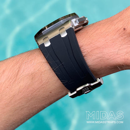 Black OEM replacement rubber strap fitted to an AP Royal Oak Offshore 26400 in an outdoor lifestyle wrist photograph.