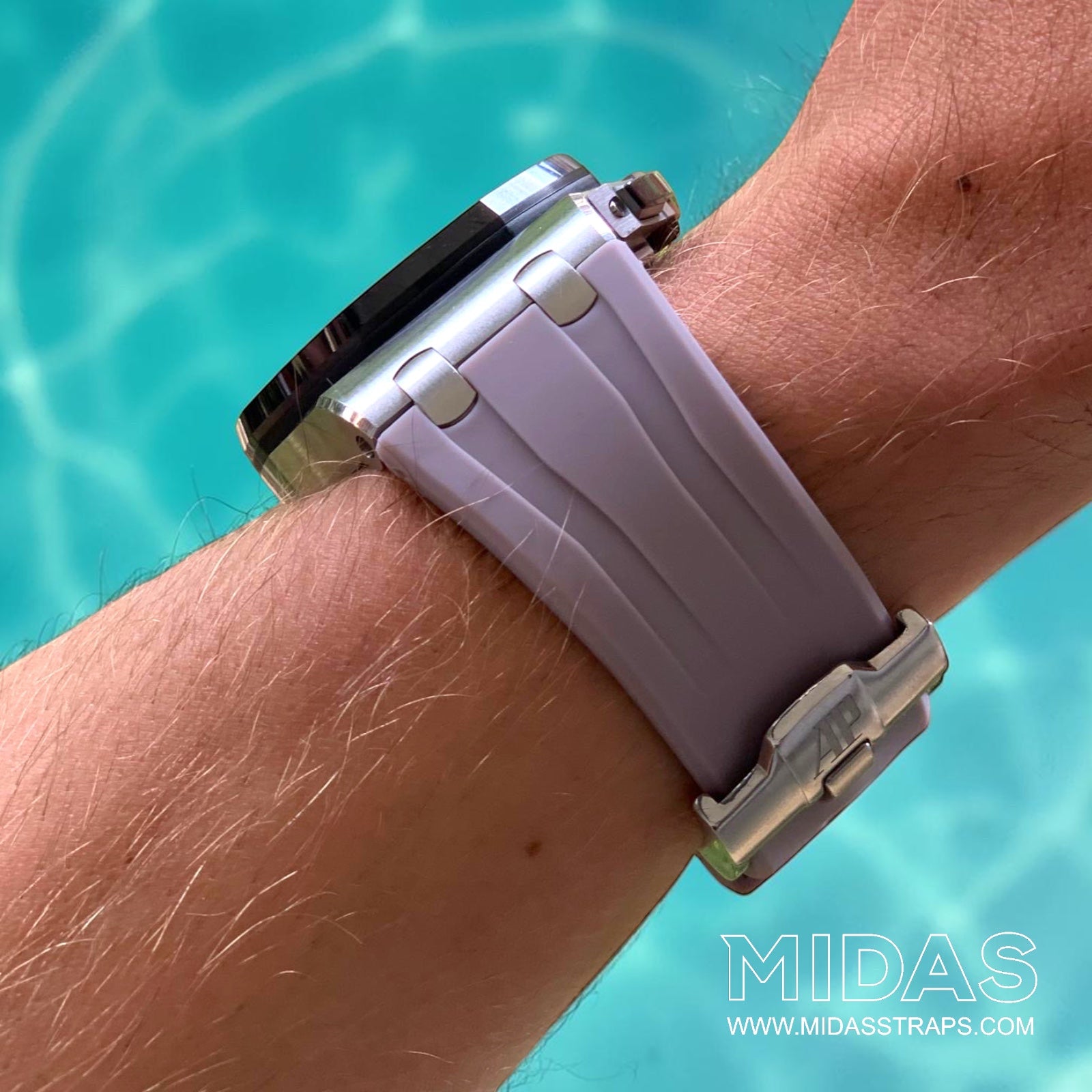 Rear wrist view of an Audemars Piguet Royal Oak Offshore 44mm with a blush pink grey replacement rubber strap in an outdoor poolside setting.