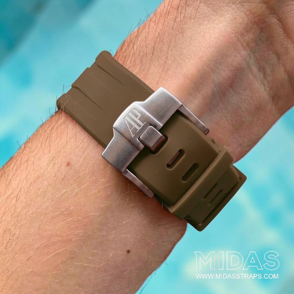 Close-up of a brown rubber OEM buckle and replacement strap clasp fitted to an Audemars Piguet Royal Oak Offshore on wrist.