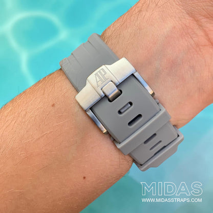 Close-up of a grey replacement rubber strap and clasp fitted to an Audemars Piguet Royal Oak Offshore watch on wrist.