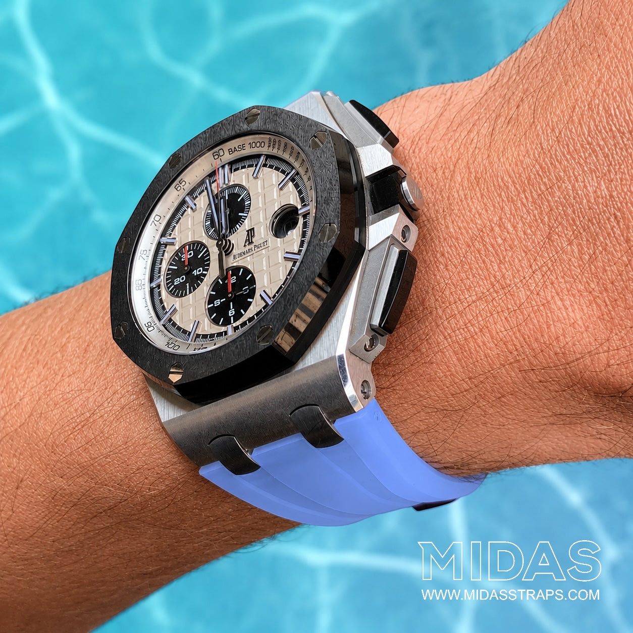 AP Royal Oak Offshore 26400 fitted with a transparent ice blue replacement rubber strap in a poolside lifestyle wrist shot.