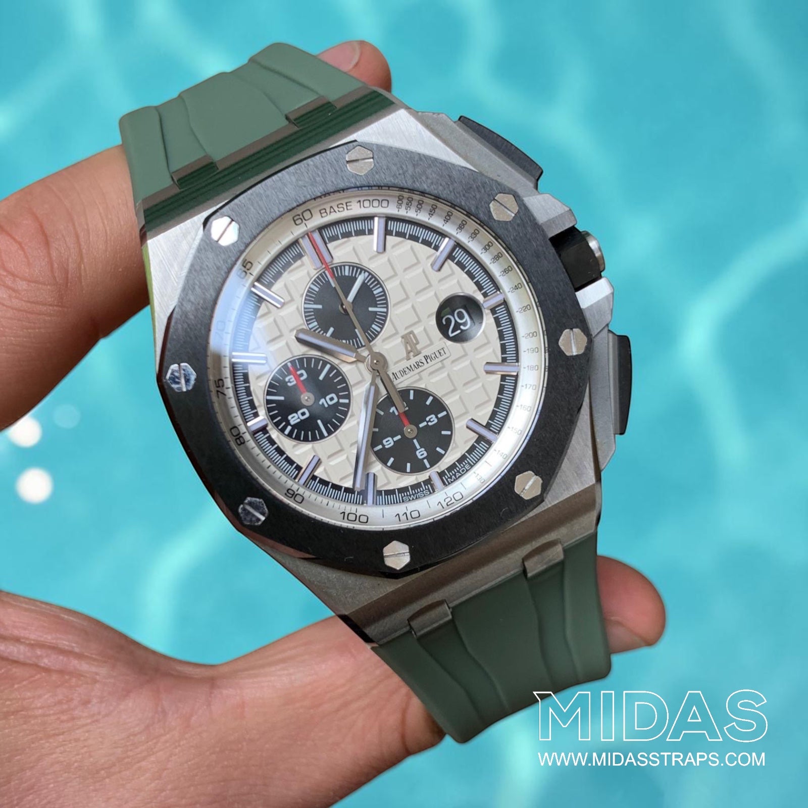 AP Royal Oak Offshore 26400 fitted with a khaki green replacement rubber strap in a hand-held lifestyle photograph.