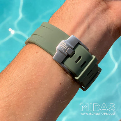Close-up of a khaki green replacement rubber strap and clasp fitted to an Audemars Piguet Royal Oak Offshore watch on wrist.