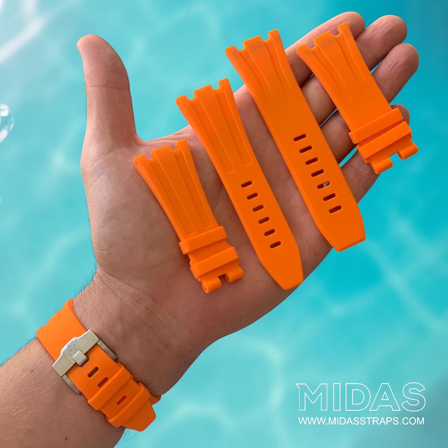Orange replacement rubber strap set by MIDAS Straps displayed in hand with an Audemars Piguet Royal Oak Offshore 44mm watch in a poolside setting.