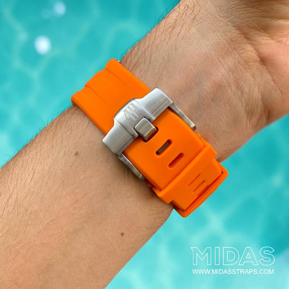 Close-up of an orange replacement rubber strap and clasp fitted to an Audemars Piguet Royal Oak Offshore watch on wrist.