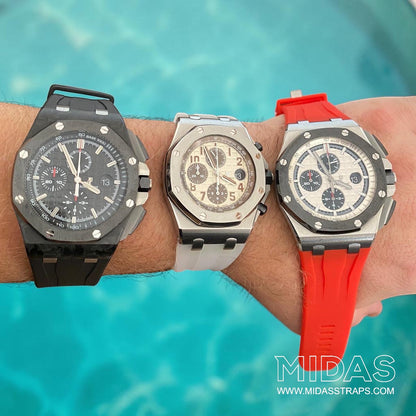 Three Audemars Piguet Royal Oak Offshore watches displayed together, including a model fitted with a red replacement rubber strap by MIDAS Straps.