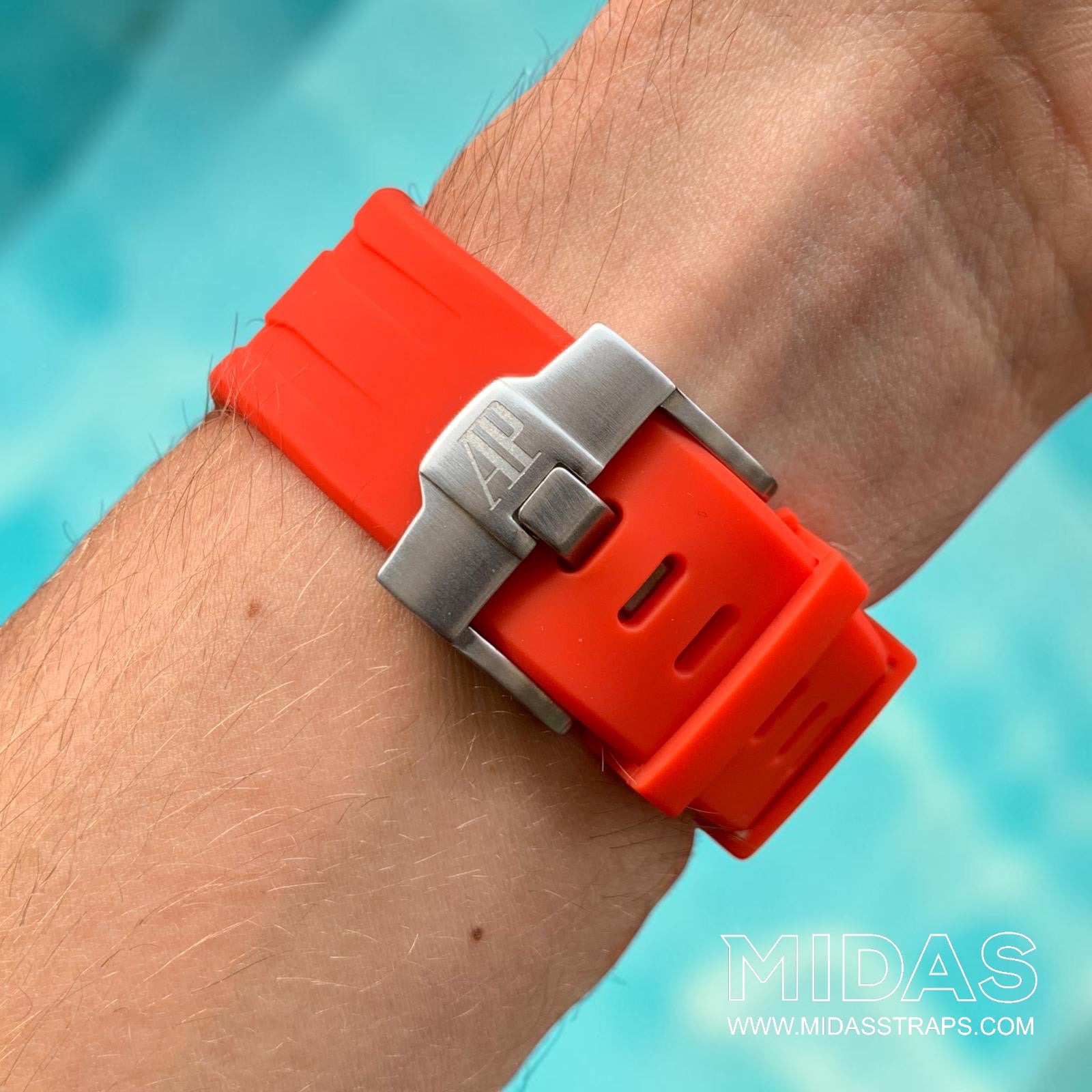 Close-up of a red replacement rubber strap and clasp fitted to an AP Royal Oak Offshore 26400 on wrist.