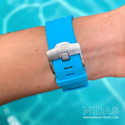 Close-up of a light blue replacement rubber strap and clasp fitted to an Audemars Piguet Royal Oak Offshore watch on wrist.