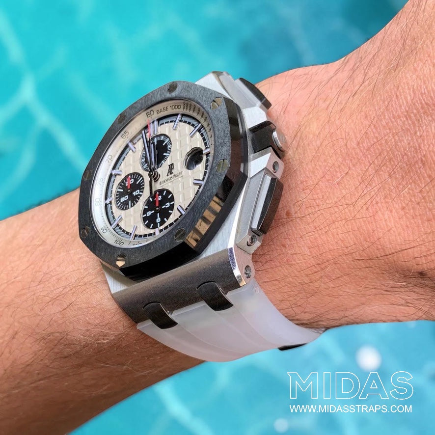 Transparent clear replacement rubber strap fitted to an Audemars Piguet Royal Oak Offshore 44mm watch on wrist beside a swimming pool.