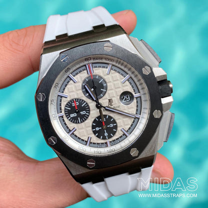 AP Royal Oak Offshore 26400 fitted with a white replacement rubber strap in a hand-held lifestyle photograph.