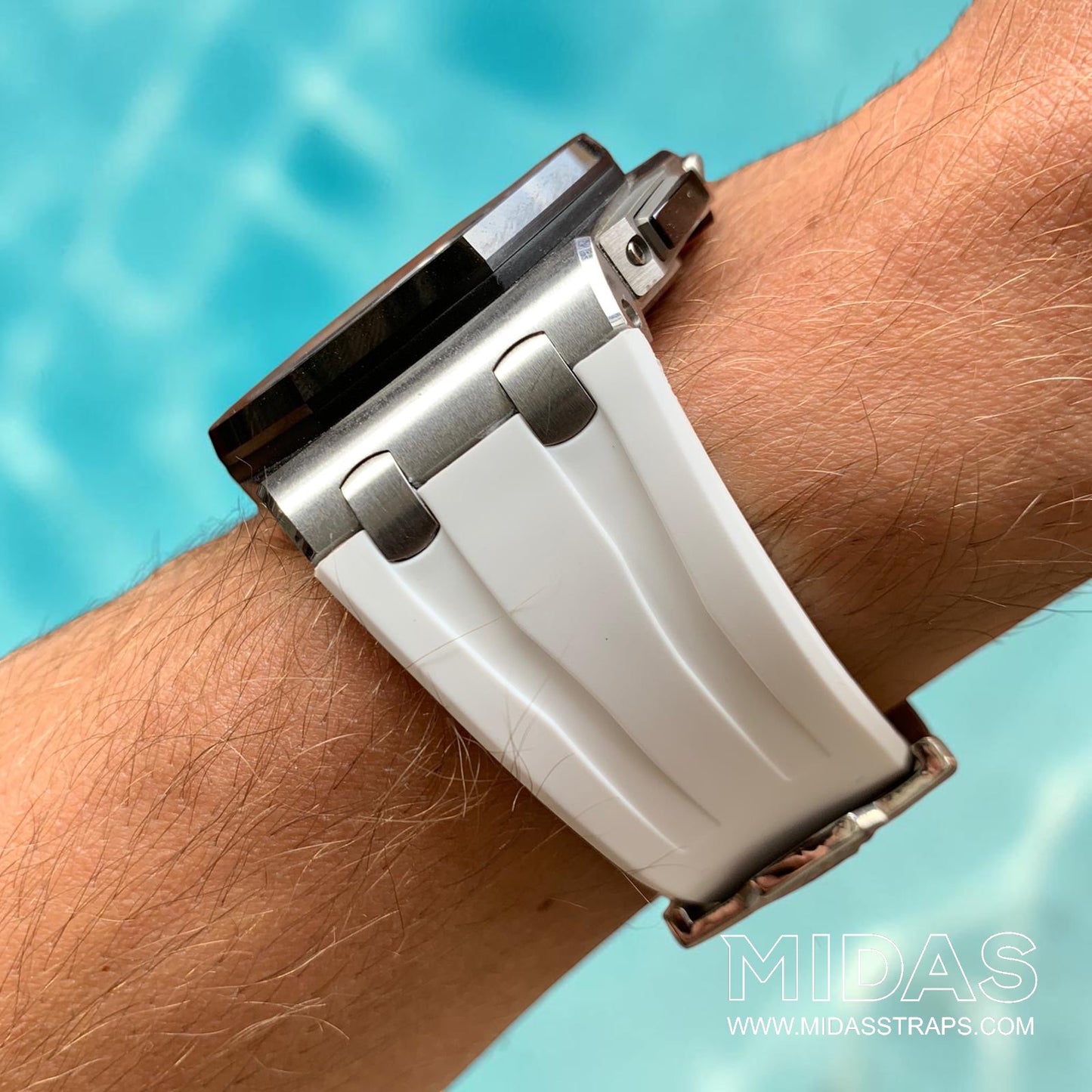Side profile of a white replacement rubber strap fitted to an Audemars Piguet Royal Oak Offshore 44mm watch on wrist beside a swimming pool.