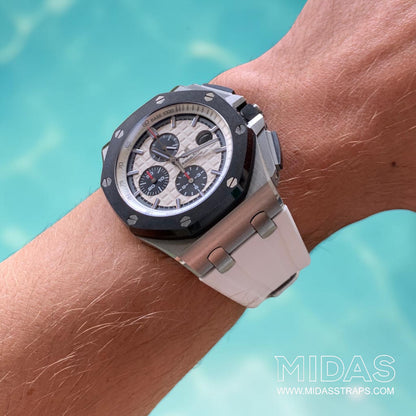 White replacement rubber strap fitted to an Audemars Piguet Royal Oak Offshore 44mm watch in an outdoor lifestyle wrist shot.