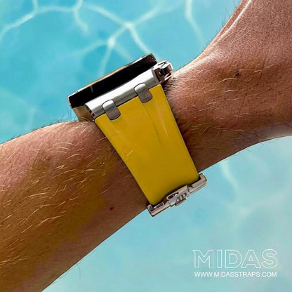 Side profile of a yellow replacement rubber strap fitted to an AP Royal Oak Offshore 26400 beside a swimming pool.