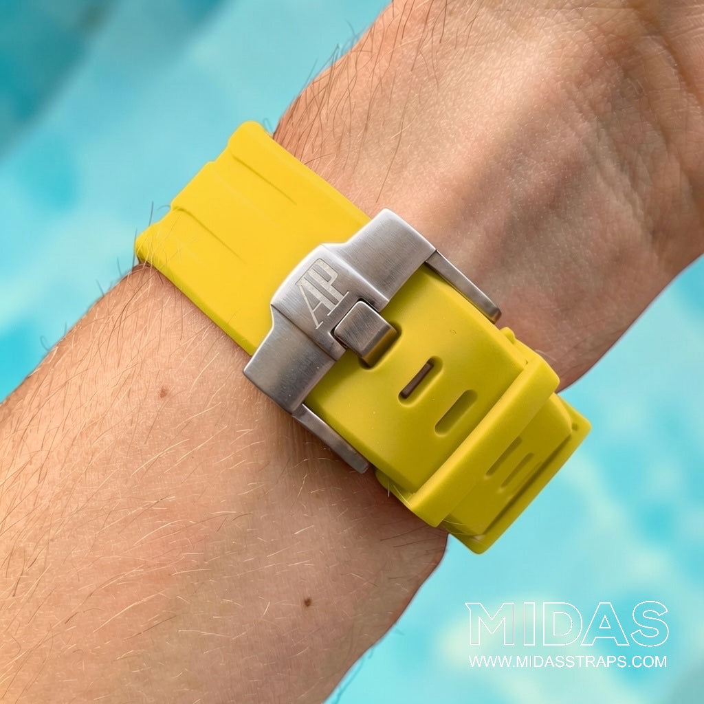 Close-up of a yellow replacement rubber strap and clasp fitted to an Audemars Piguet Royal Oak Offshore watch on wrist.