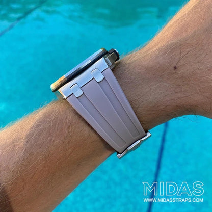 MIDAS Royal Oak Offshore 42mm blush grey rubber strap on wrist outdoor pool background